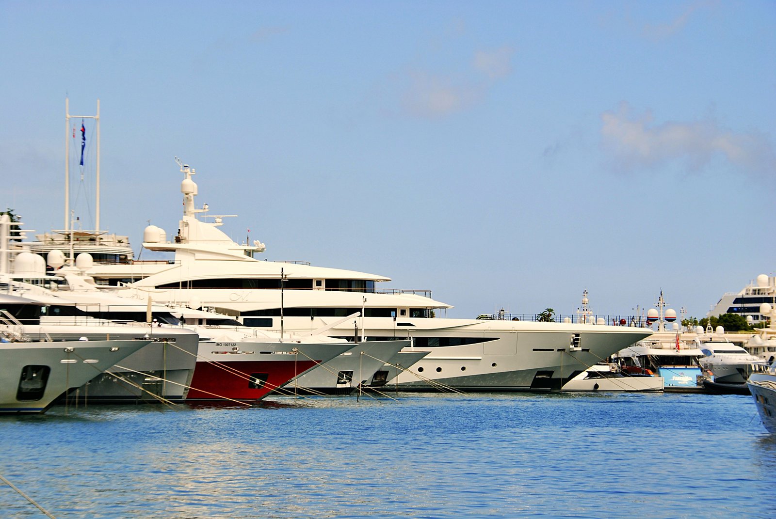 Stunning view of luxury yachts docked in the sunny Marina of Monaco.