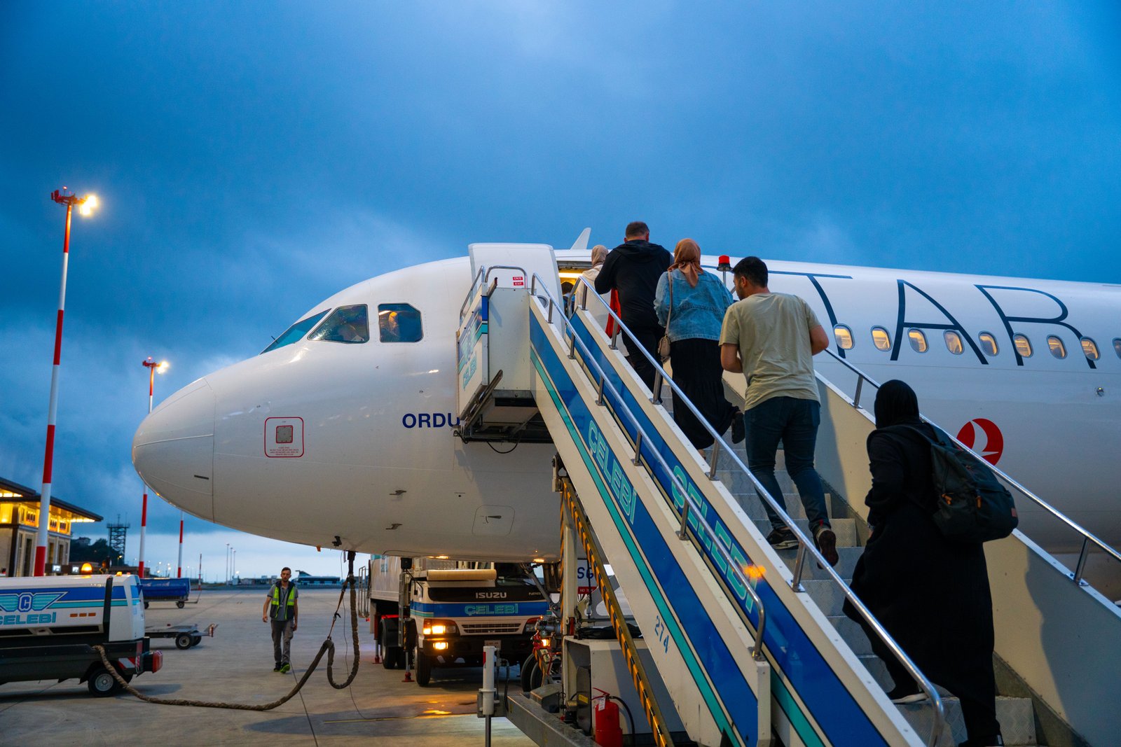 Travelers boarding plane at Rize Airport in Türkiye, showcasing modern air travel.