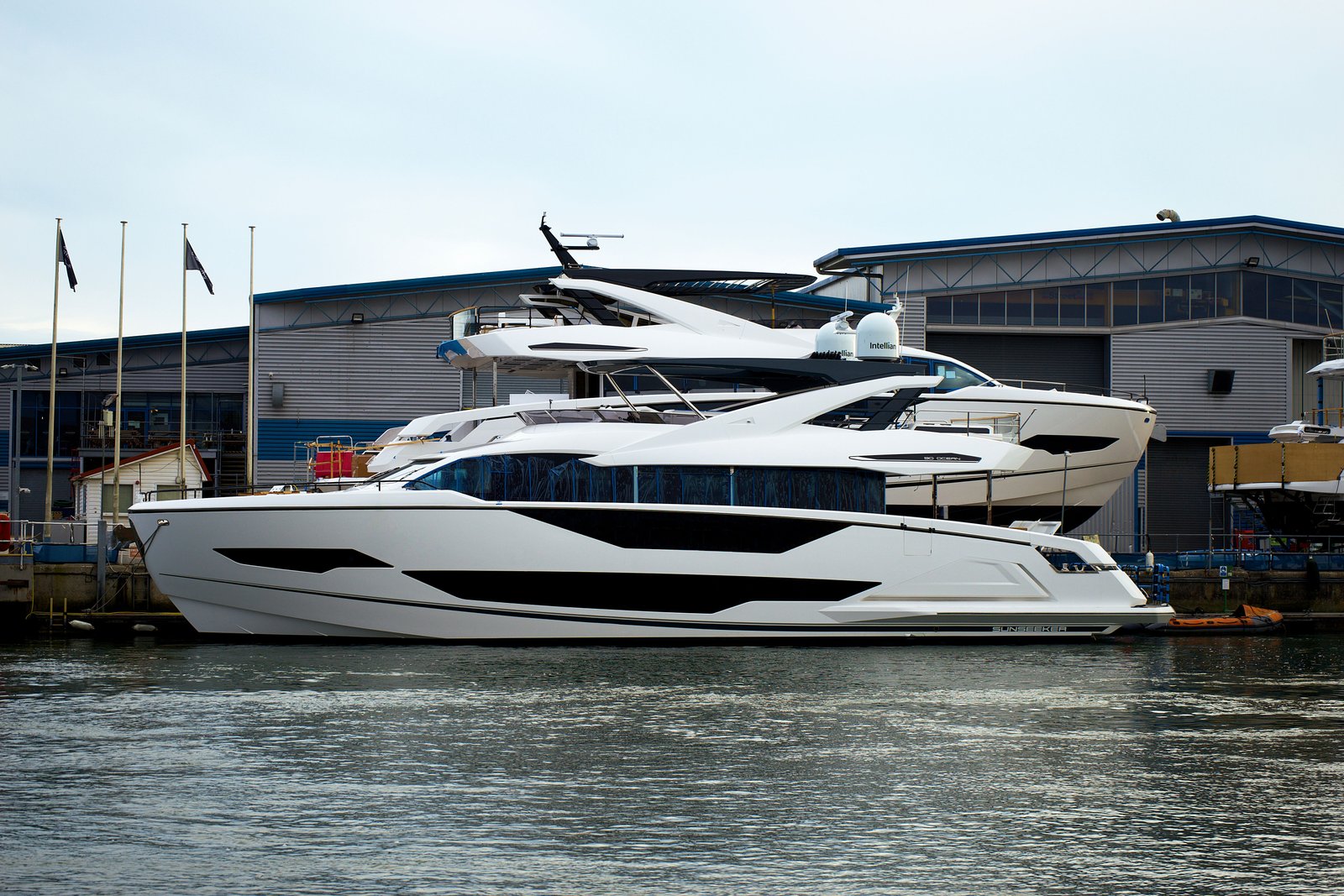 Elegant luxury yachts moored at Poole Marina, showcasing modern watercraft design in England.